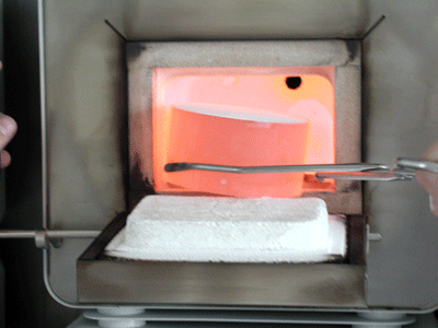 Red hot preheated mold is taken out of the kiln for casting